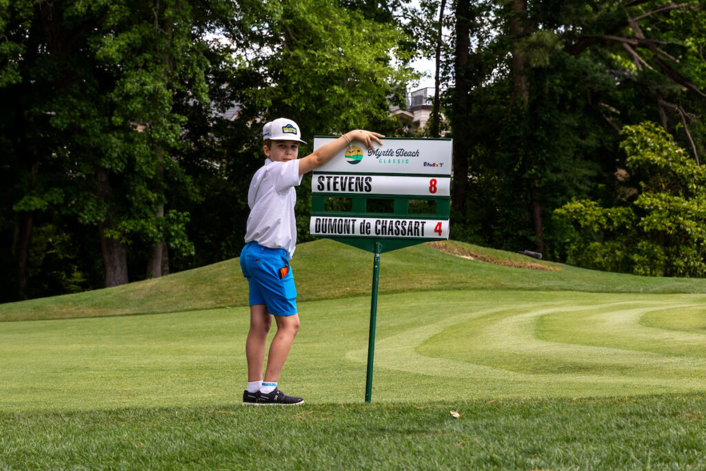 Boy holds sign at 2024 Myrtle Beach Classic.